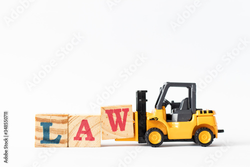 Toy forklift hold wood letter block W to complete word law on white background