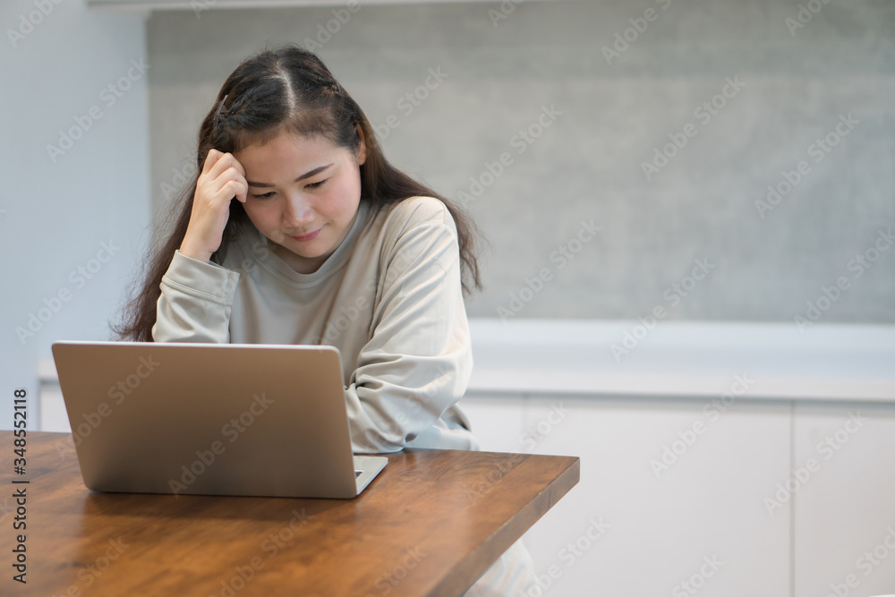 Asian women work from home and stressed due to work problems after being affected by the disease And from a reduced salary. Concept of coronavirus (COVID-19) quarantine Asian women work from home and stressed due to work problems after being affected by the disease And from a reduced salary. Concept of coronavirus (COVID-19) quarantine
