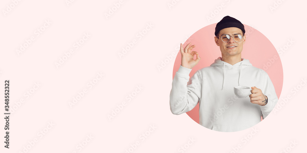 Portrait of young man on bright bicolor background. Beautiful caucasian male model. Nice coffee. Human emotions, expression, sales, ad concept. Youth culture. Modern artwork, design, trendy.