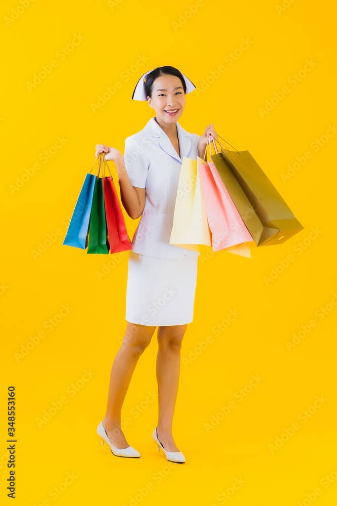 Portrait beautiful young asian woman thai nurse with shopping bag and credit card Portrait beautiful young asian woman thai nurse with shopping bag and credit card