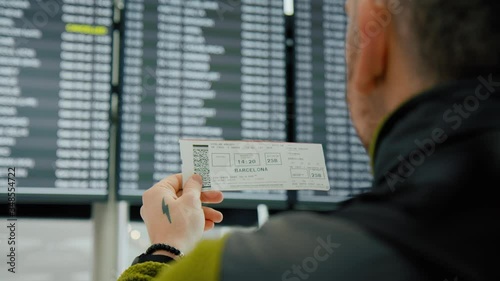 Citizen try to return home. Traveller or tourist search for cancelled or delayed flight on information screen in airport. Vacation or summer holiday cancellation. Suspended flights to spain, barcelona
