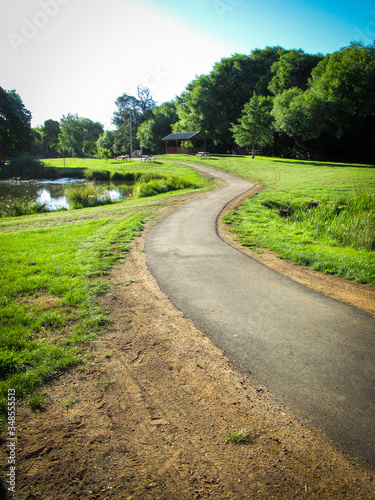 Walkway leading to a shelter in a public park. Suitable to illustrate an article about dream interpretation or psychology. Footpath in a dream symbolizes a new way to solve current or previous issues