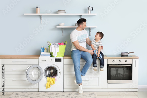 Man and his little son doin...