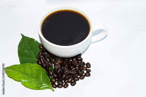 Roasted coffee beans with a white coffee mug