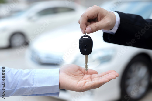 Salesman is carrying the car keys