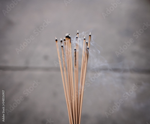 Incense sticks burning with smoke Asian temple