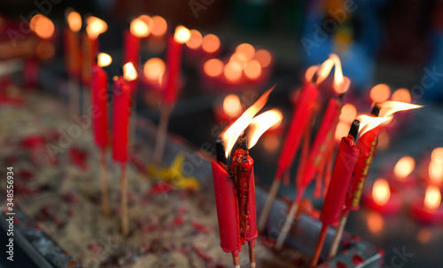 burning red chinese candles in Wat Mangkon Kamalawat temple photo