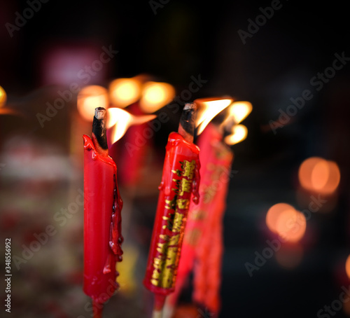 burning red chinese candles in Wat Mangkon Kamalawat temple photo