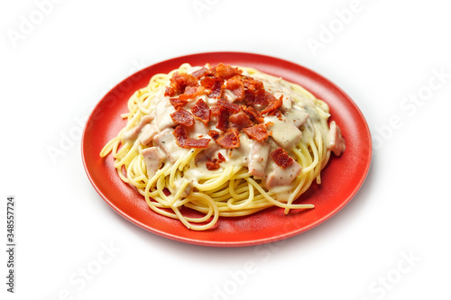 Spaghetti pasta, carbonara cream sauce with ham and bacon Italian cuisine isolated on white background.