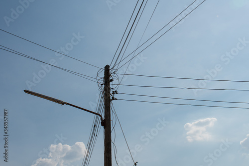 high voltage power lines against blue sky