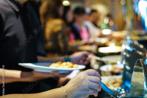 Crowd of people enjoying buffet food meal dining Food Options Eating Concept