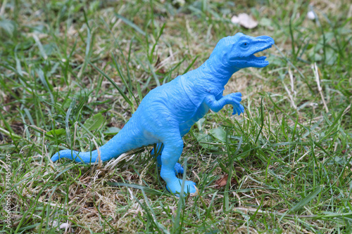 T REX Dinosaurs model on grass background photo