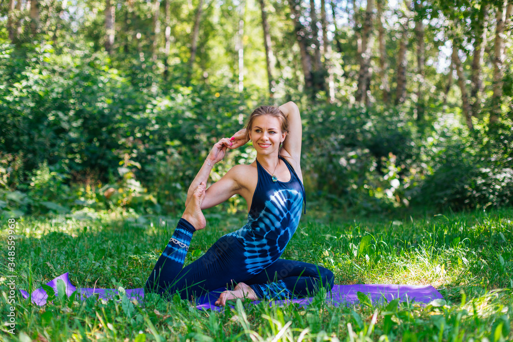 Young woman doing yoga exercises in summer city park. Young woman doing yoga exercises in summer city park.