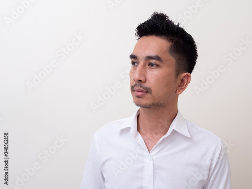 Young Asian man isolated on white background looking sideways © rufous