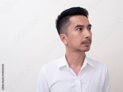 Young Asian man isolated on white background looking sideways © rufous