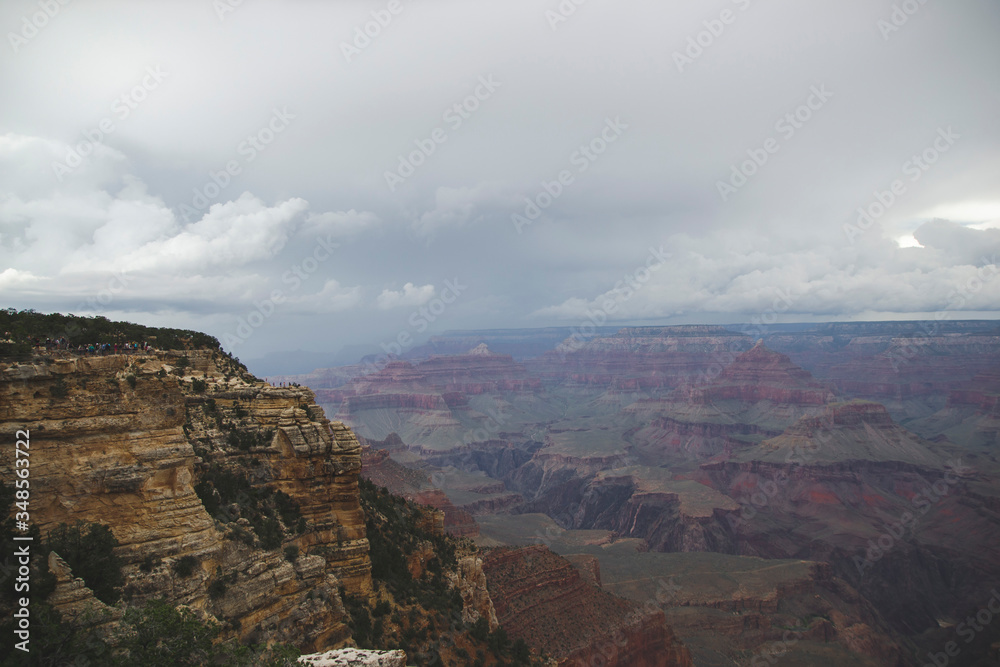Grand Canyon in Arizona state, United States of America world famous landmark. Cloudy weather above yellow rocks with trees with beautiful landscape. Travel background from vacation, memory card. 