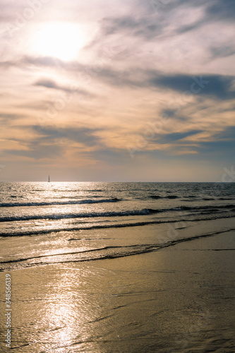 beach with calm sea and a beautiful sky at sunset