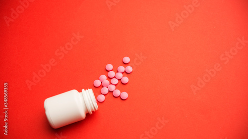 Spilled pills or tablets as pattern from a plastic drugs bottle