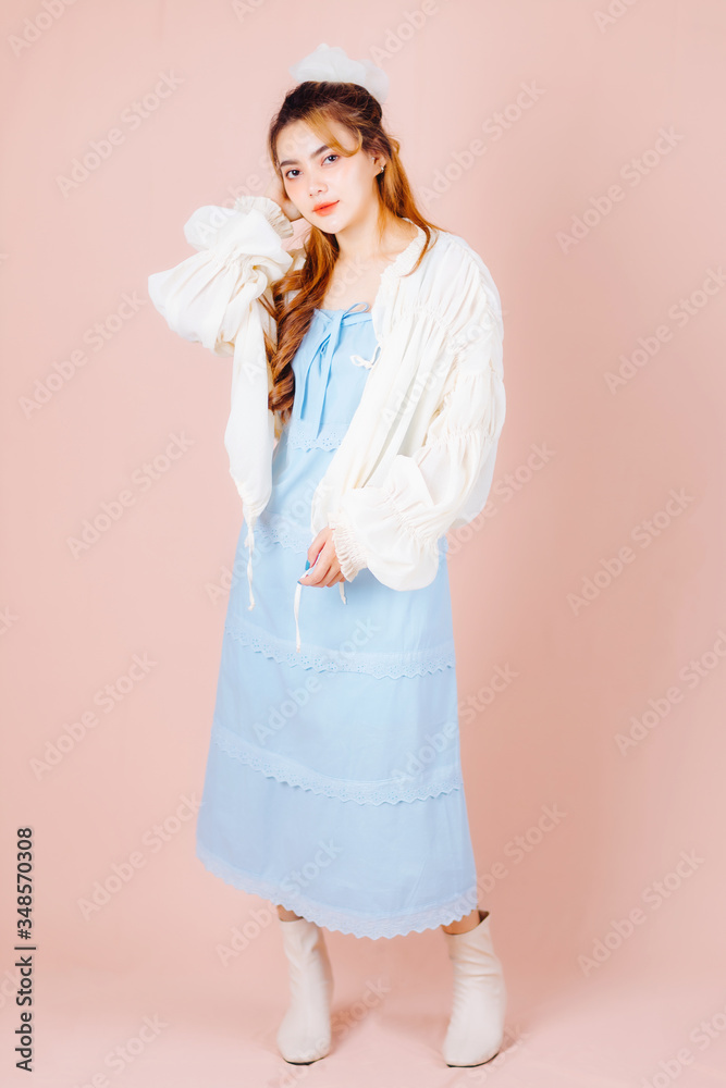Beautuful Asian woman wearing white and blue shirts on pink background. Beautuful Asian woman wearing white and blue shirts on pink background.