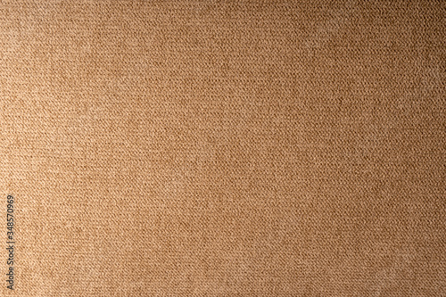 Brown fabric background, top view.