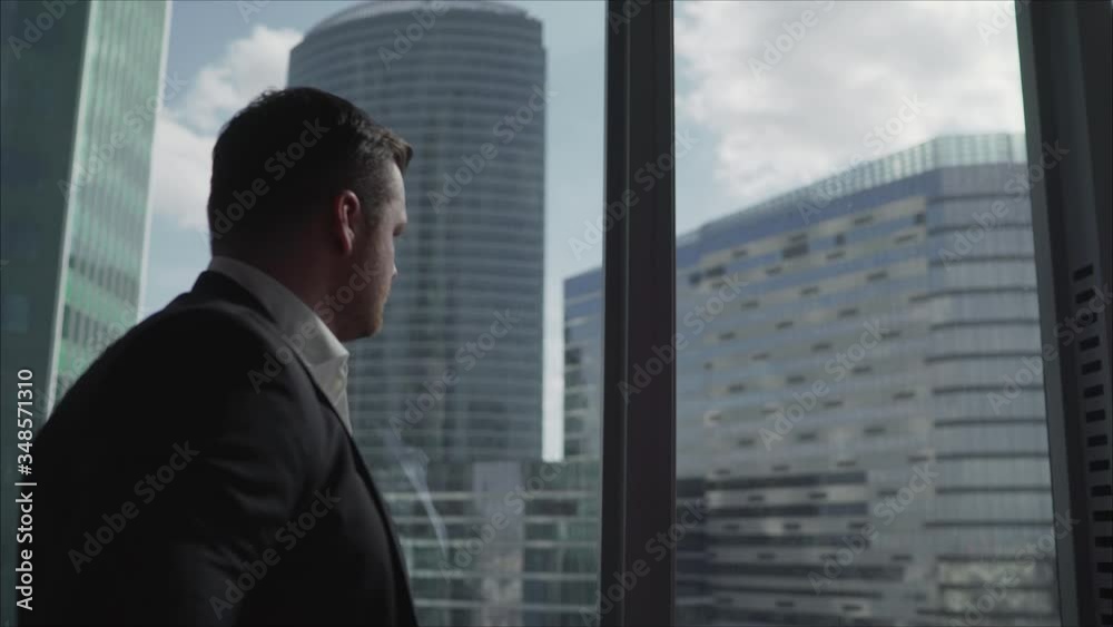 Pensive businessman in his office. Businessman walking in his office. Pensive businessman in his office. Businessman walking in his office.