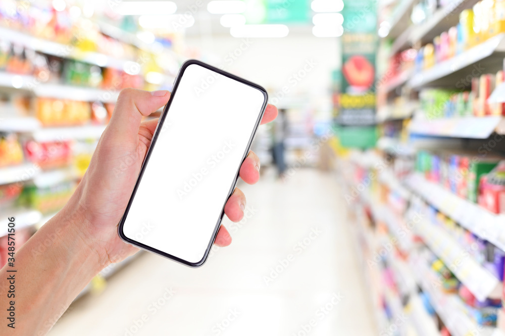 Man hand holding smartphone in supermarket ,Empty white screen smartphone for design advertising on mobile phone screen ezy replace with clipping path Man hand holding smartphone in supermarket ,Empty white screen smartphone for design advertising on mobile phone screen ezy replace with clipping path