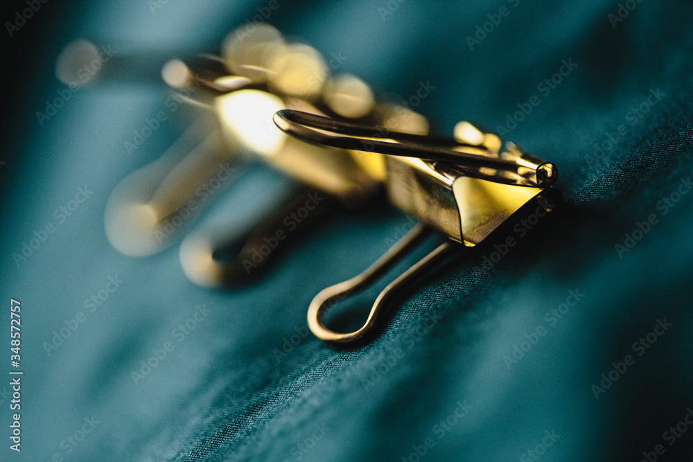 Closeup macro photo of golden office pin. Conceptual picture with group and one apart from all Closeup macro photo of golden office pin. Conceptual picture with group and one apart from all