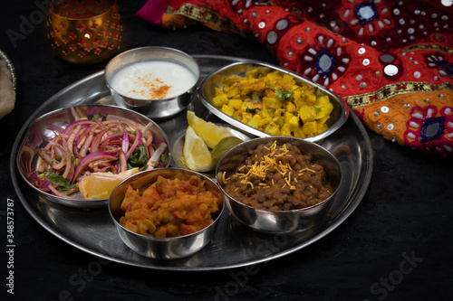 North Indian vegetarian food served in thali style along with garlic butter naan