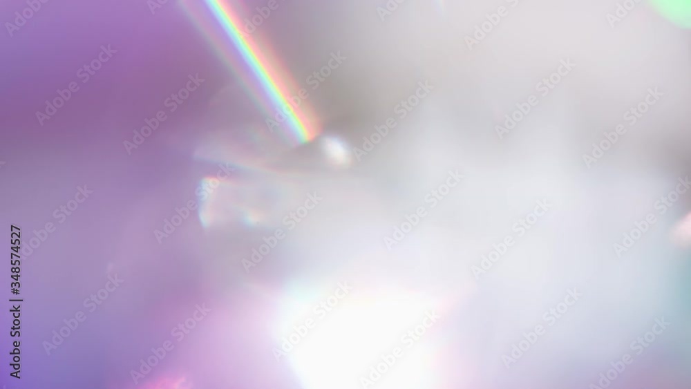 Optical Refraction in Violet Tones. Loop. The light passes through the facets of a slowly rotating diamond and creates repetitive sparkling highlights and rainbow colors