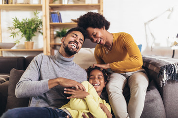 Happy african american family having fun at home.