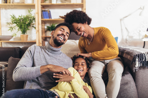 Happy african american family having fun at home.