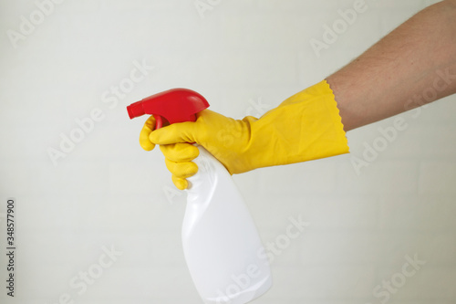 The human hand holds in his hands a bottle of household chemicals for cleaning and disinfection of the room