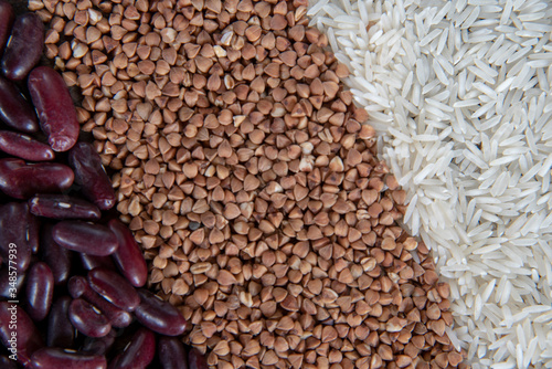 Raw rice, buckwheat and beans are laid out in strips as a backdrop.