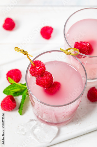 Raspberry Tequila Shots Lemonade Cocktail with Fresh Raspberry on White Background. Selective focus.