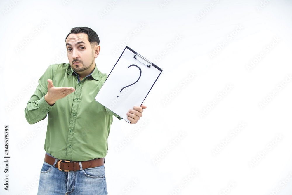 Perplexed businessman in casual clothes is showing a paper holder with question mark written on it, looking puzzled at the camera, asking for help. Perplexed businessman in casual clothes is showing a paper holder with question mark written on it, looking puzzled at the camera, asking for help.