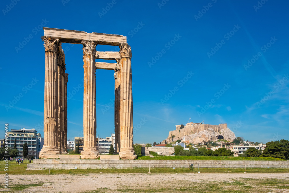 Panoramic view of Temple of Olympian Zeus, known as Olympieion at Leof Andrea Siggrou street in ancient city center old town borough in Athens, Greece, with Acropolis in backgrund