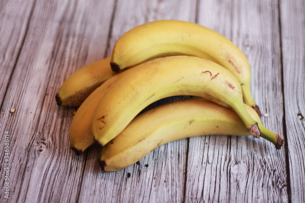 bunch of bananas on wooden table
