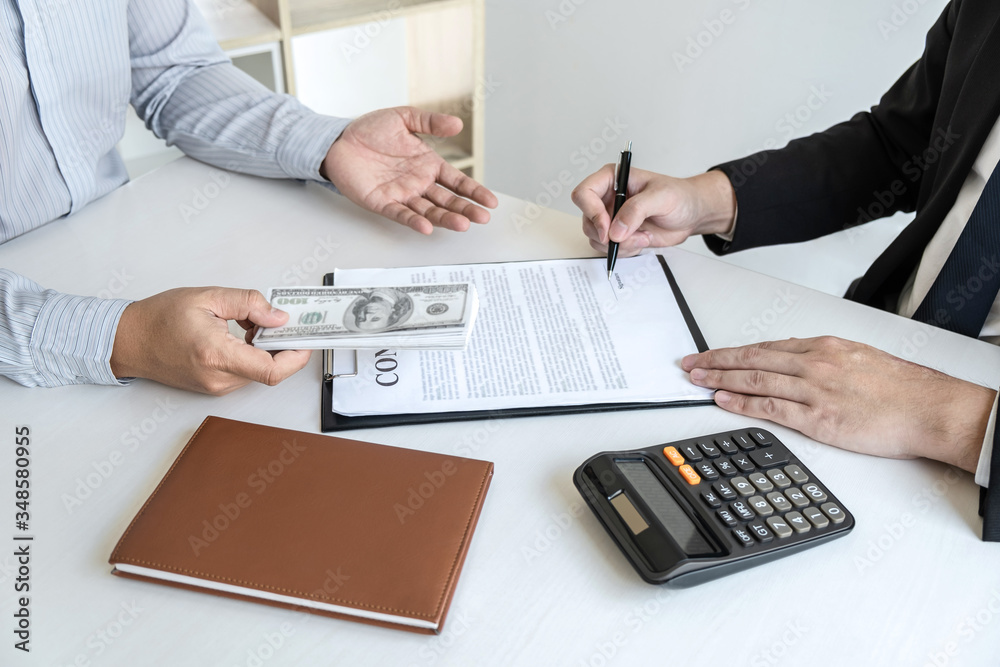 Illegal, dishonest, bribery and corruption concept, Businessman giving bribe money in the envelope of their partner to give success the deal contract in a corruption scam for bribing Illegal, dishonest, bribery and corruption concept, Businessman giving bribe money in the envelope of their partner to give success the deal contract in a corruption scam for bribing