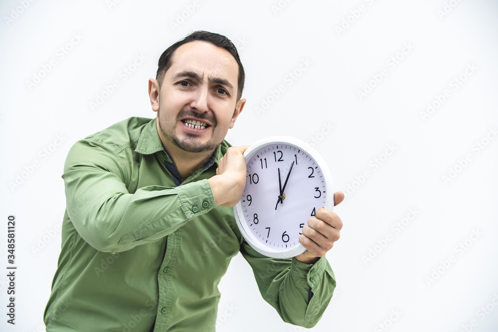 Irritated businessman trying to destroy a white alarm clock. Fight for flexible hours. Irritated businessman trying to destroy a white alarm clock. Fight for flexible hours.