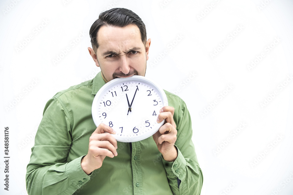 Totally exhausted man biting an alarm clock on a white background. Totally exhausted man biting an alarm clock on a white background.