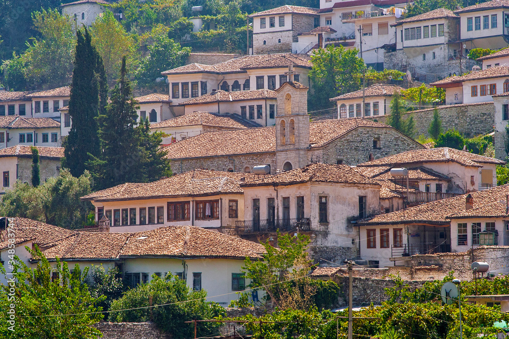 Fototapeta premium Albania - Berat - The historical white houses under red tile with church and bell tower in UNESCO world heritage site