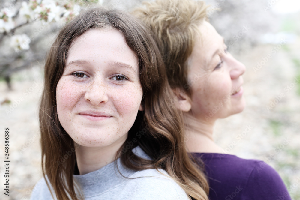 Fototapeta premium Portrait of beautiful woman and her teenager daughter