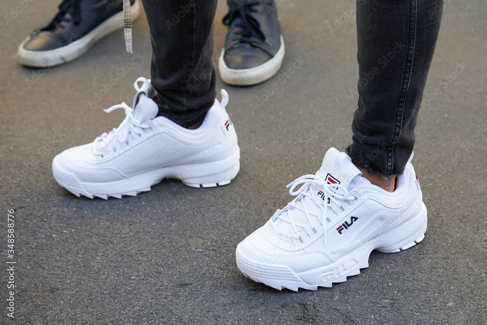 Konsekvent til stede Energize Woman with white Fila sneakers and black trousers on September 23, 2018 in  Milan, Italy Stock Photo | Adobe Stock