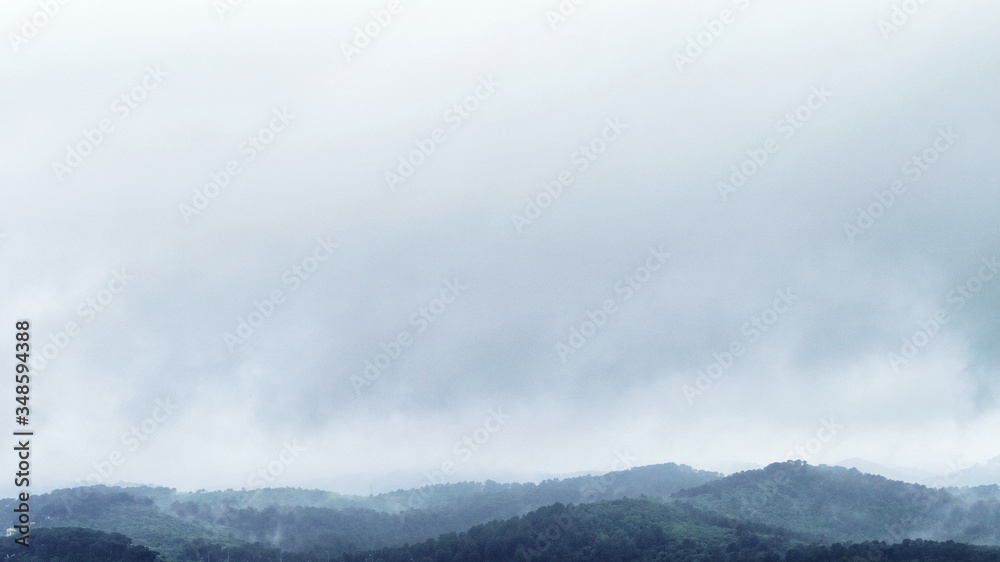 Obraz premium View of the sky and part of the mountains after rain. Darkness, natural haze and evaporation.