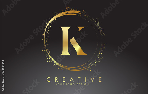K golden letter logo with golden sparkling rings and dust glitter on a black background. Luxury decorative shiny vector illustration.