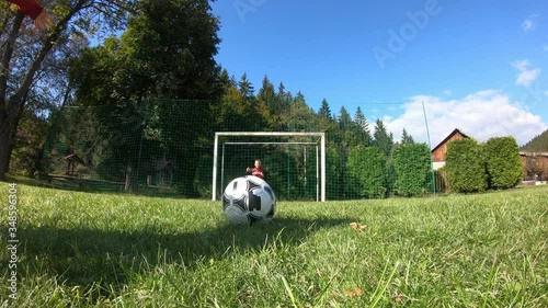 Young children playing soccer. The boy shoots at the goalkeeper and rejoices at the goal.
