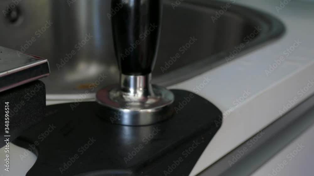 Barista making espresso coffee on stainless steel coffeemaker or coffee machine Barista making espresso coffee on stainless steel coffeemaker or coffee machine