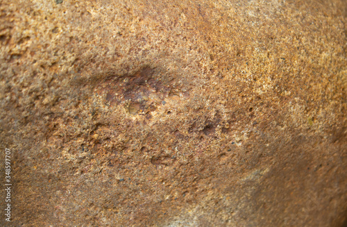 the surface of a yellow stone with a brown tint
