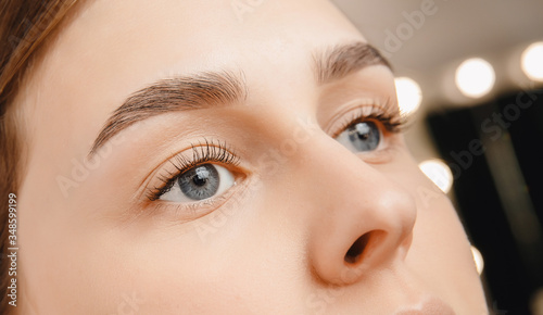 Young woman with beautiful eyebrows. Correction of brow hair photo