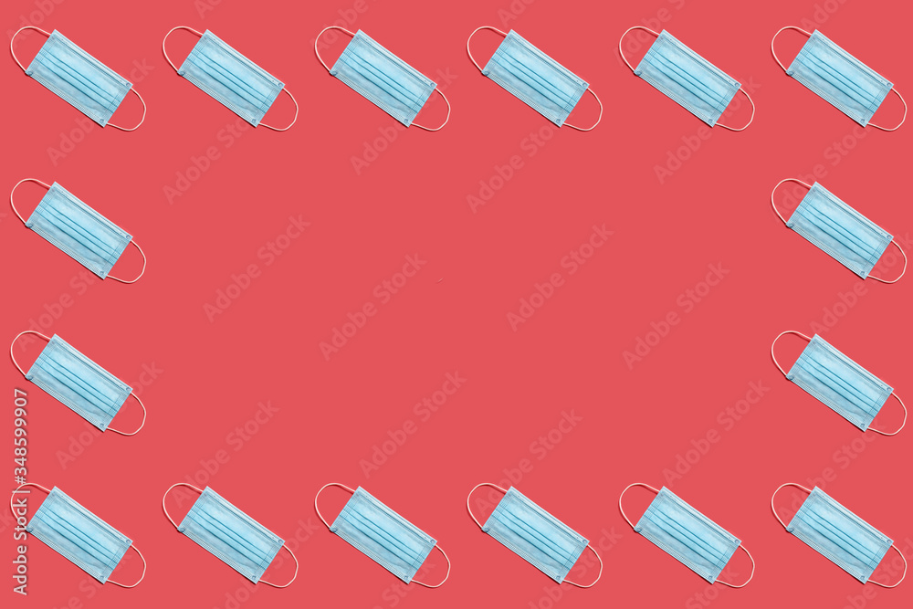 COVID-19 disposable surgical face mask on red background. Protection against coronavirus. Healthcare and medical concept. Seamless medical pattern with copyspace